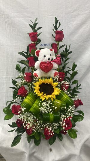 Arreglo floral con peluche