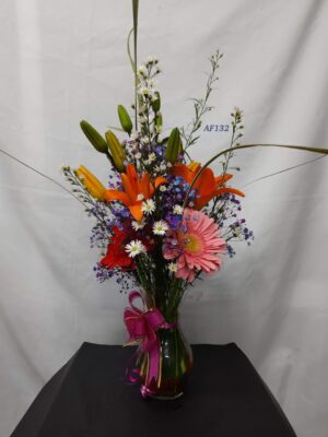 florero de cristal lirios y gerberas